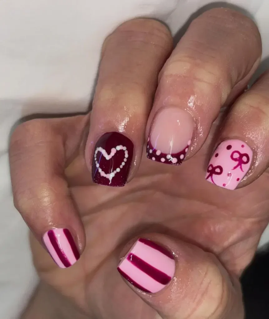 Cute Pink Acrylic Nails With Hearts, Bows, and Playful Valentine Details