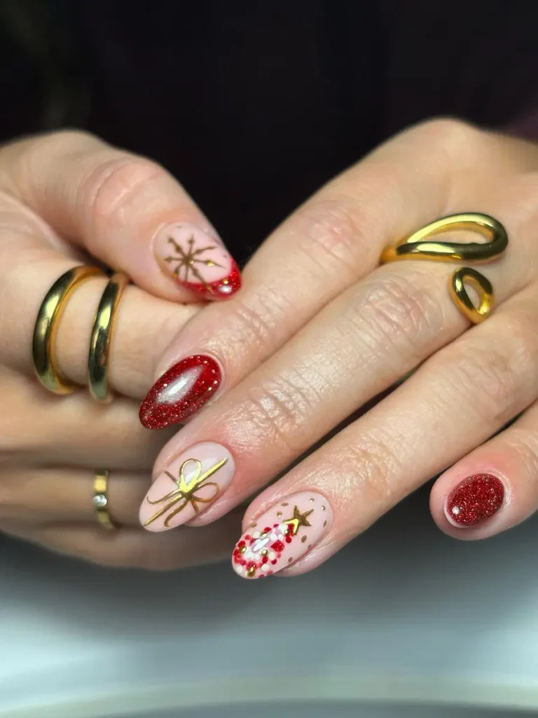 Festive Red and Gold Nails With Bow, Star, and Sparkle Accents