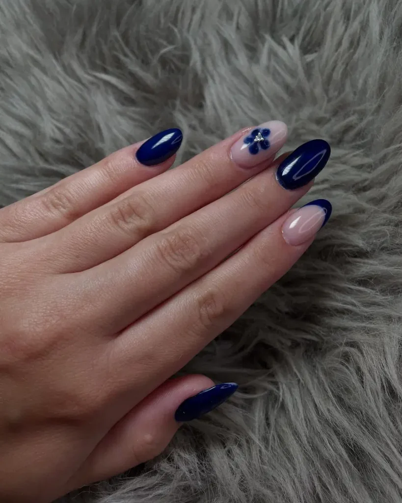 Deep Navy Almond Nails With a Soft Floral Accent