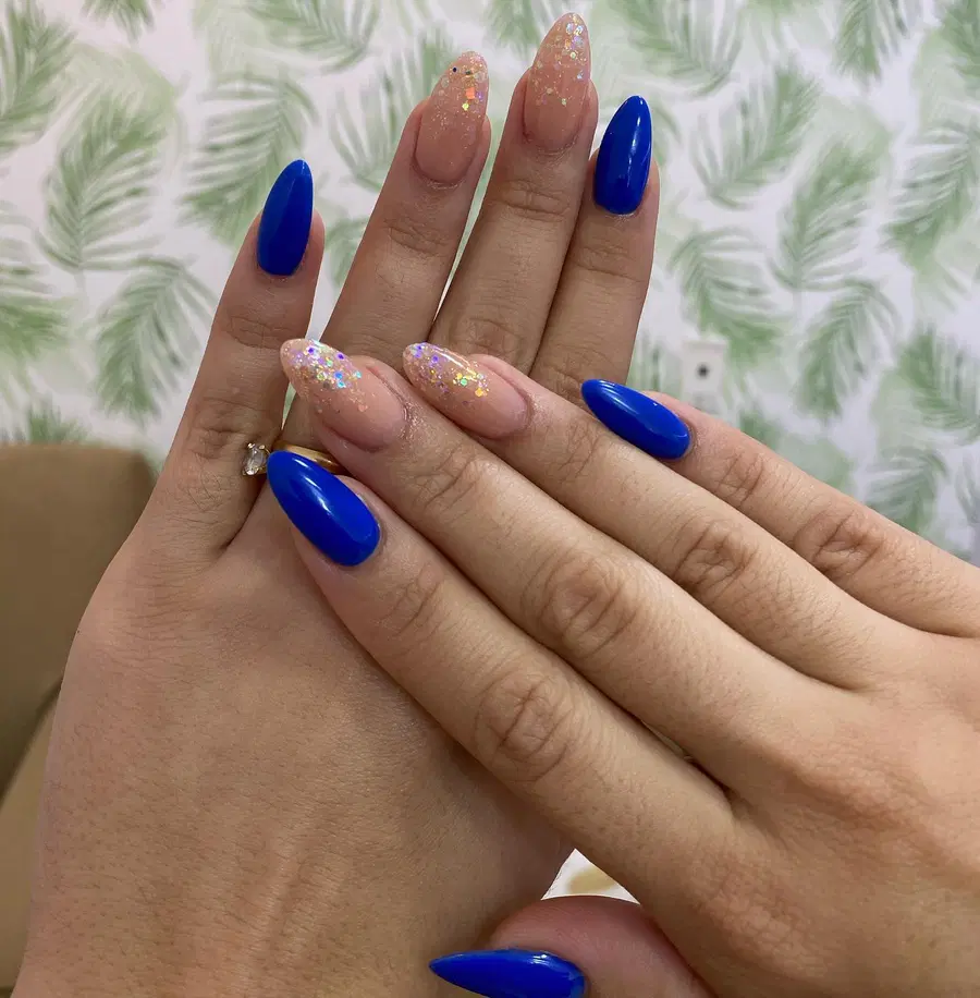 Blue Almond Nails With Glossy Solids and Soft Glitter Accents