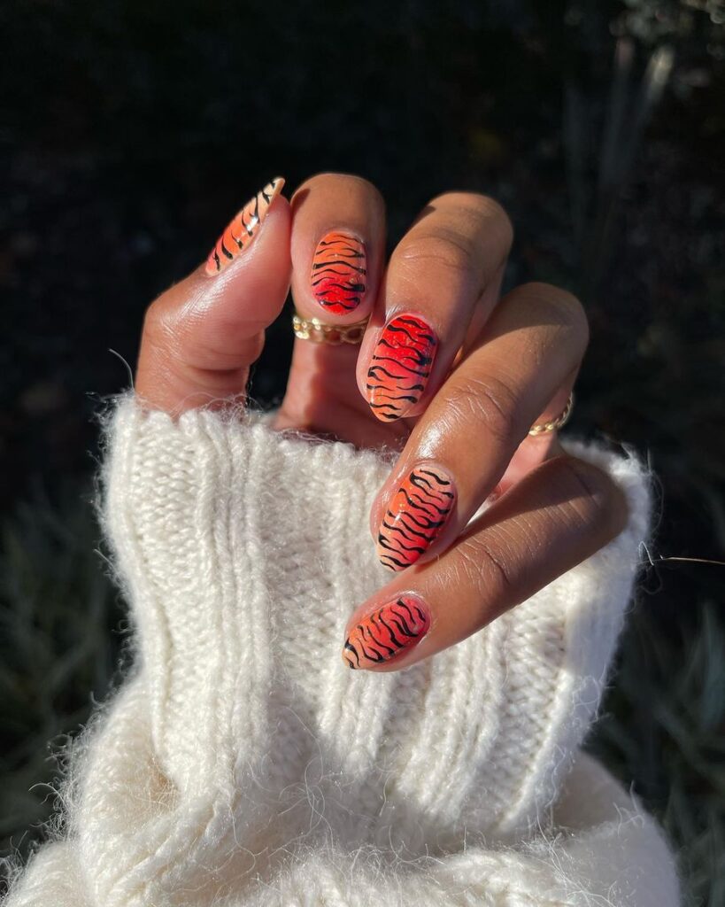 Red Ombre Nails with Bold Animal Pattern