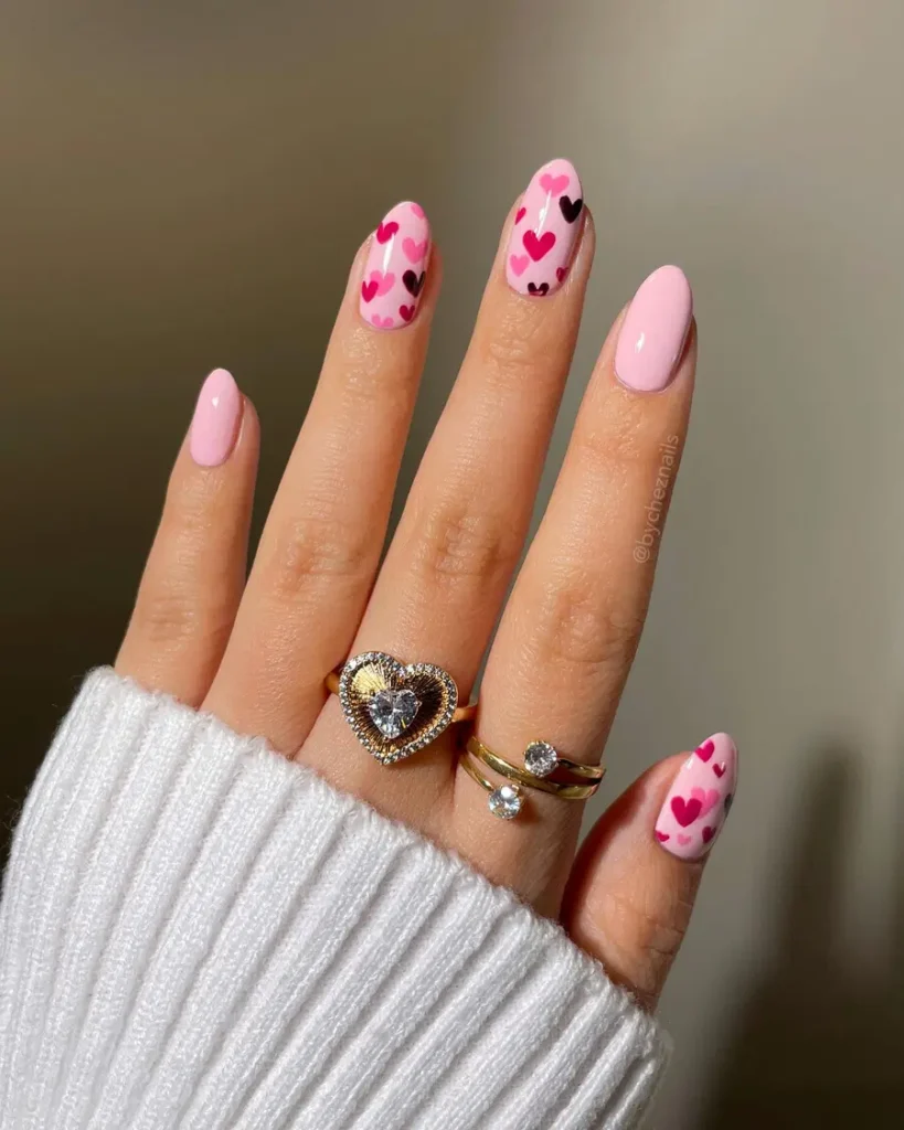 Light Pink Almond Nails With Playful Heart Prints
