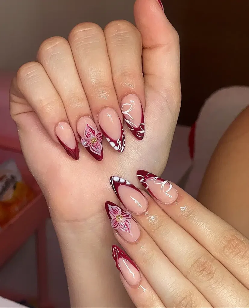 Red Almond Nails With Floral Accents and Soft Line Details