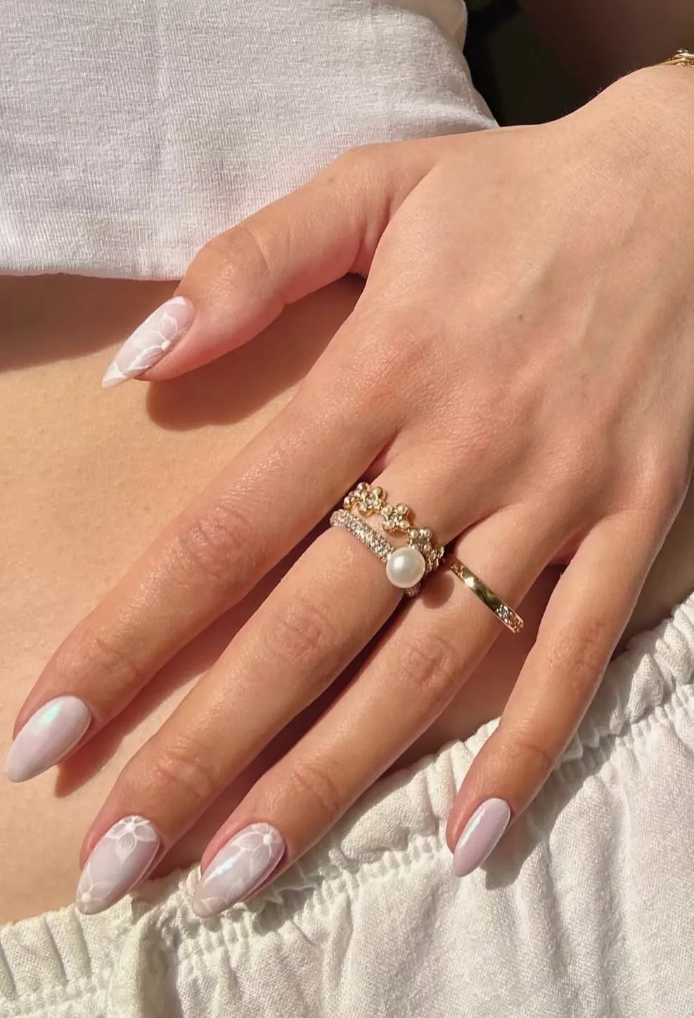 Milky White Almond Nails with Subtle Floral Linework