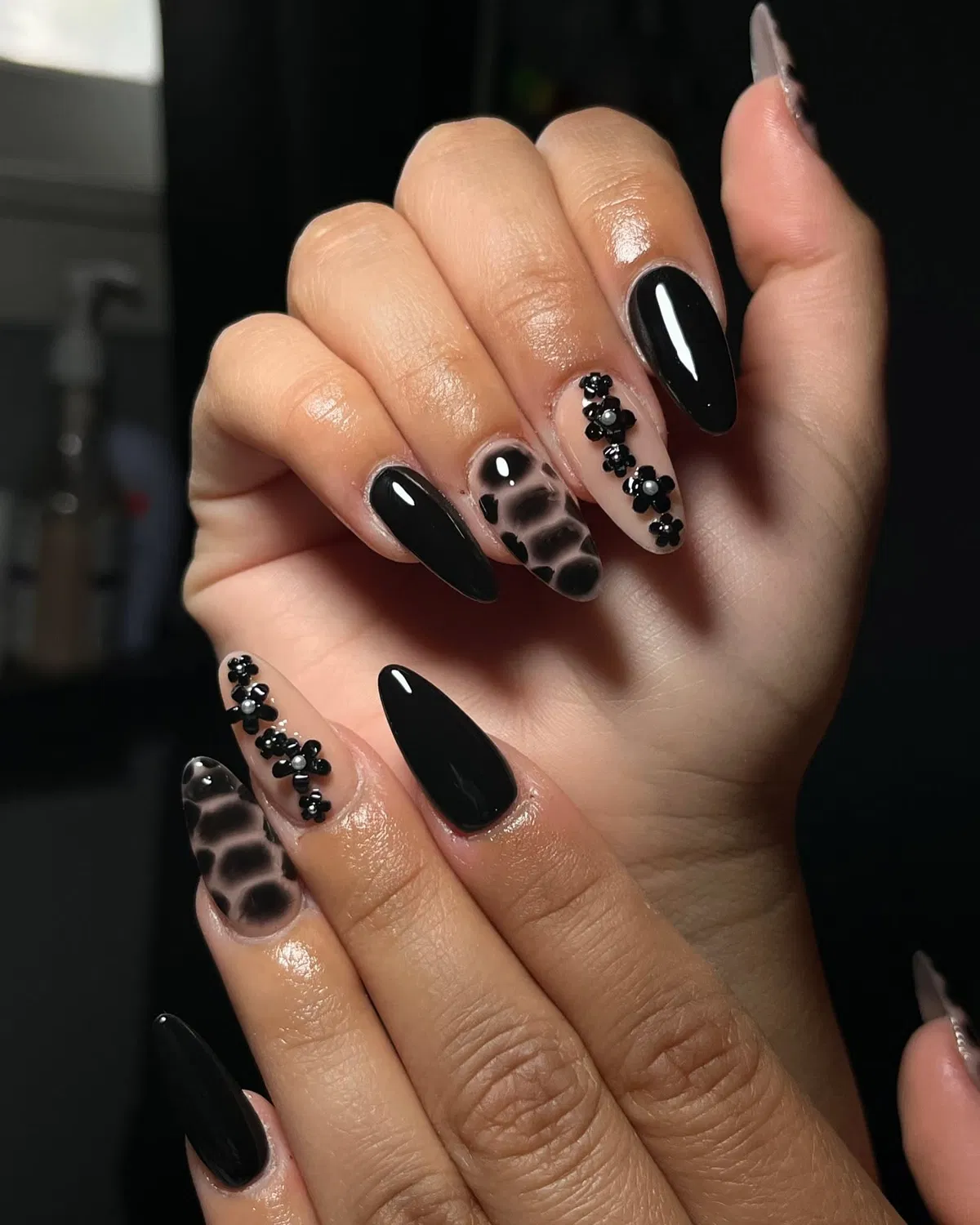 Solid black with spotted nude accent and raised floral embellishments