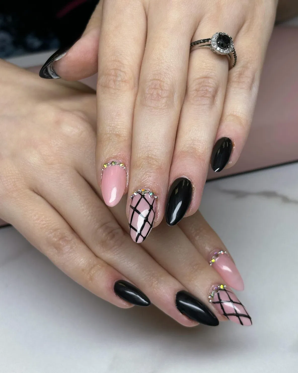 Black and pale pink mix with grid accents and cuticle gems
