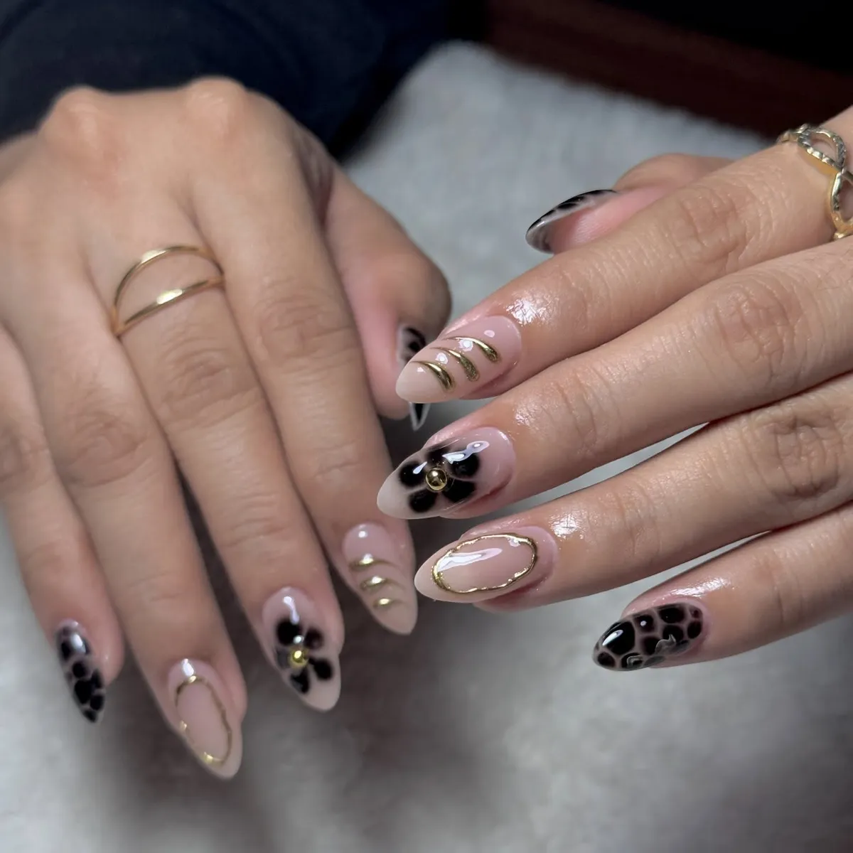 Nude base with black floral accents and gold outlines