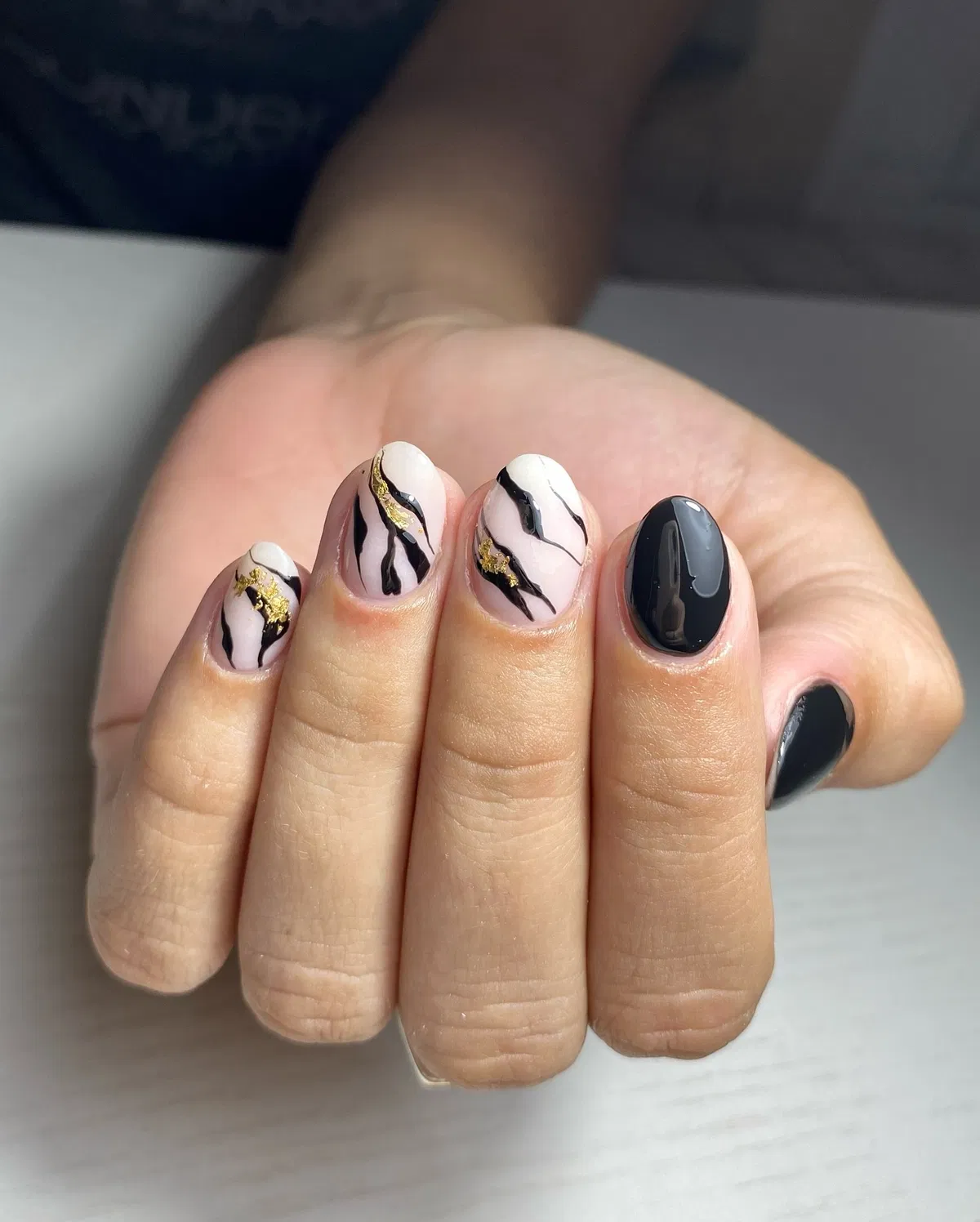 Wavy black lines with scattered gold accents
