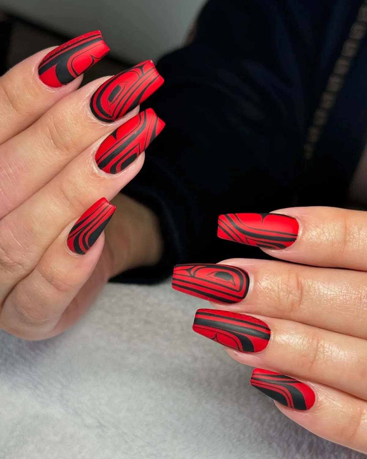 Abstract black swirls over red