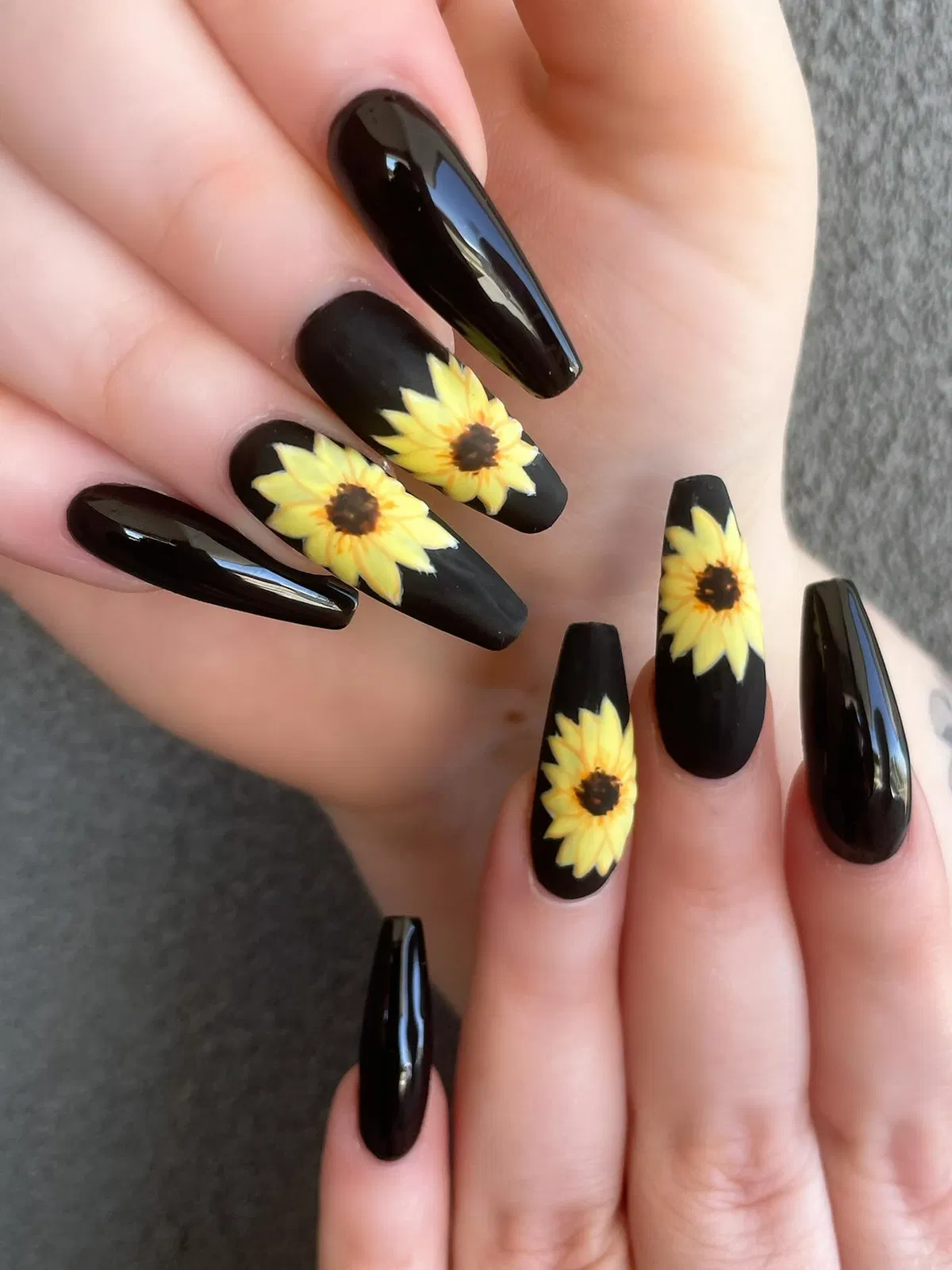 Glossy black coffin nails with large yellow flower accents