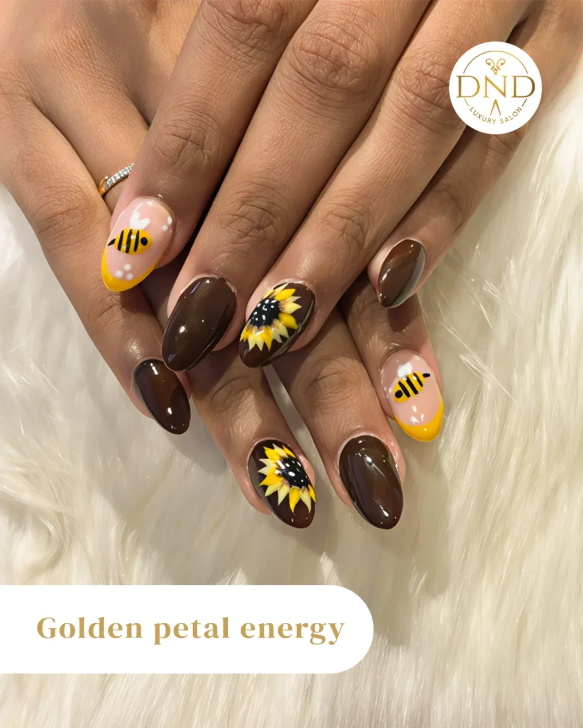 Glossy brown with sunflower accents and bee-tipped nude nails