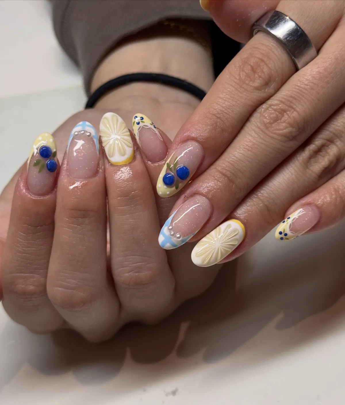 Mixed French tips with raised citrus slices and blue accents