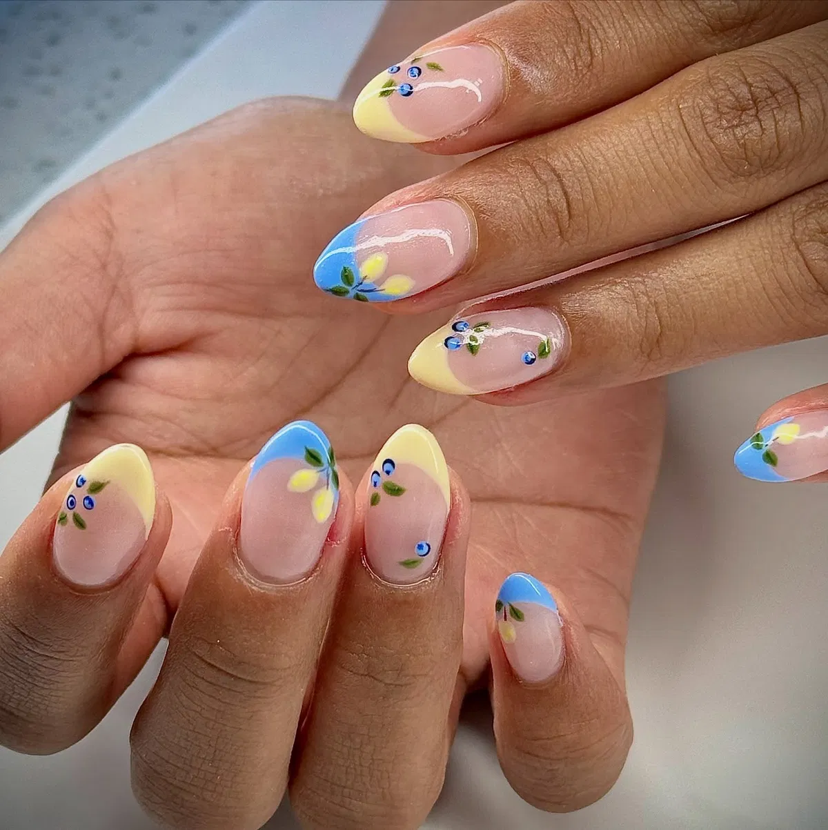 Sheer pink with pastel color-block tips and tiny blue accents