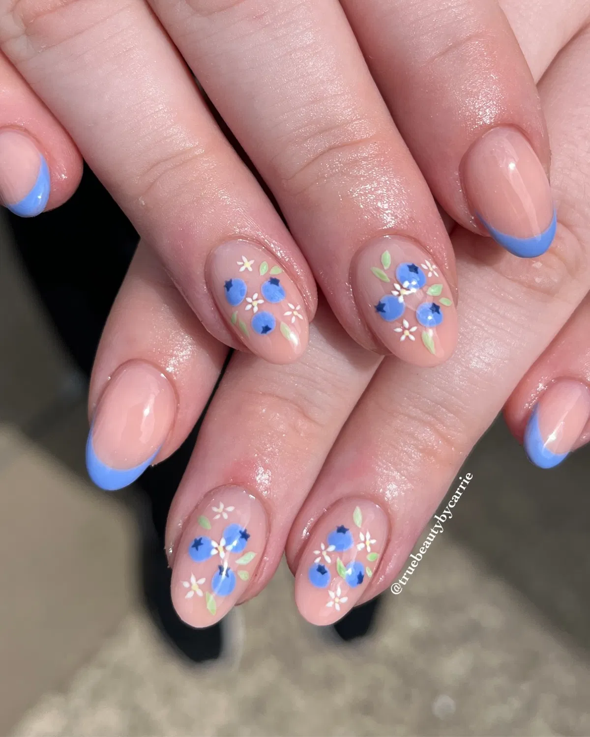 Blue French tips with small floral-and-blue motifs