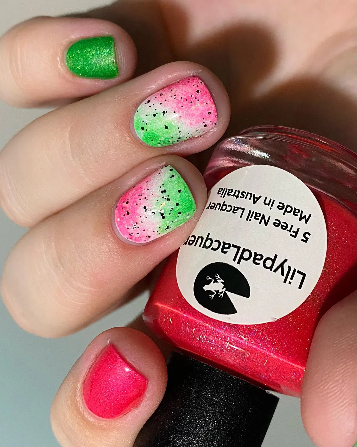 Pink-green gradient with black speckles