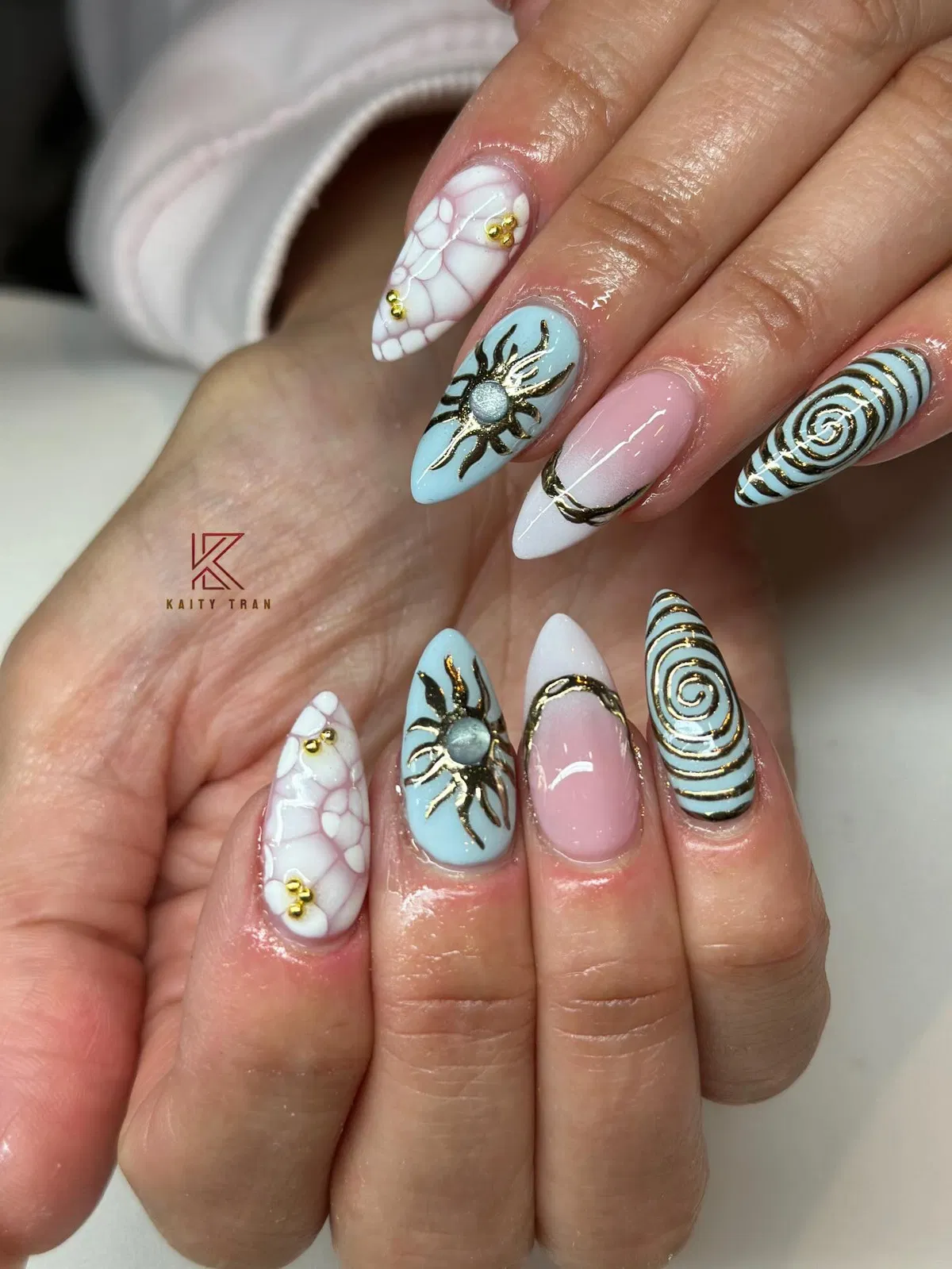 Light blue and pink with gold line art