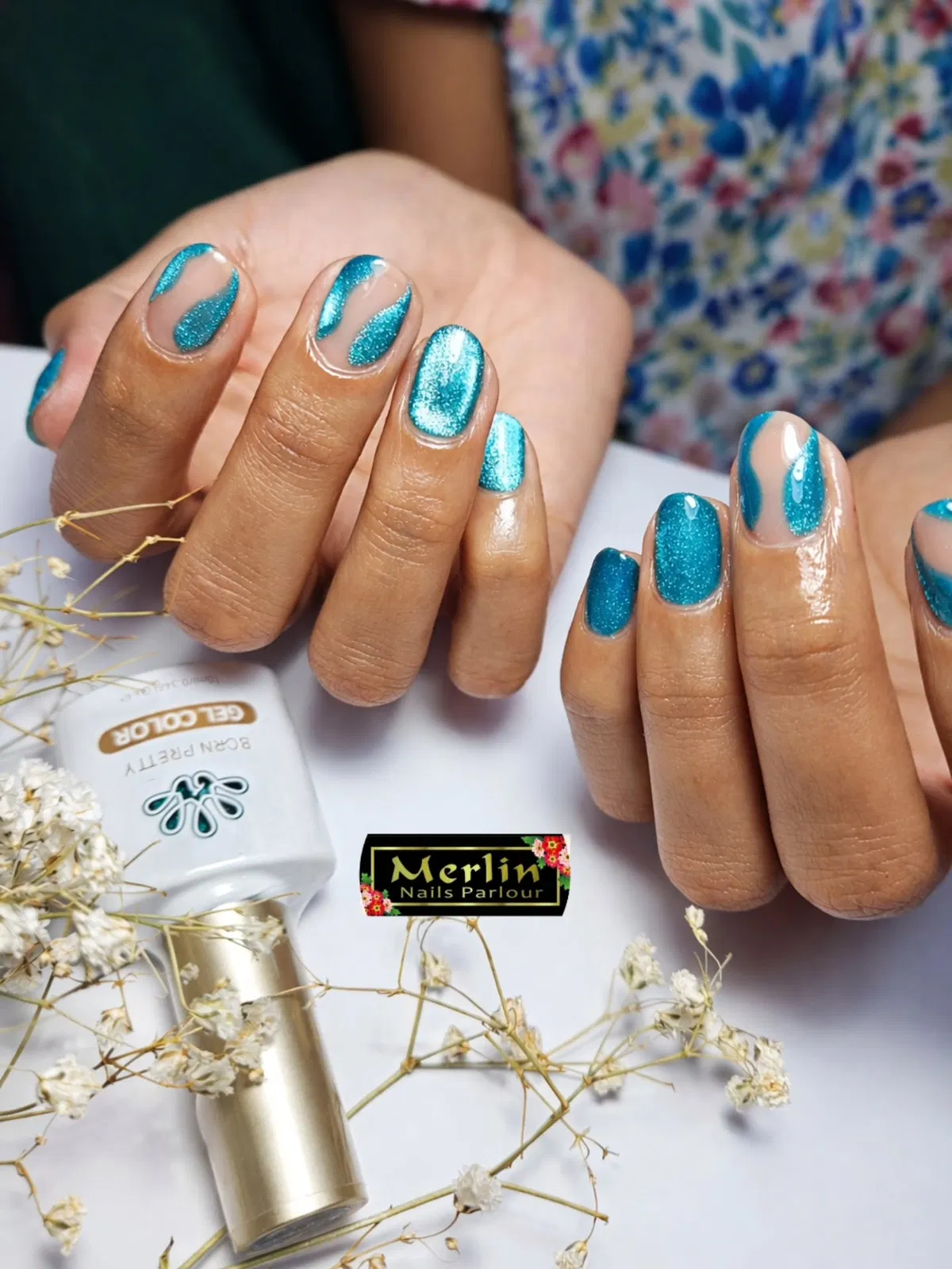 Teal shimmer nails with curved negative-space details