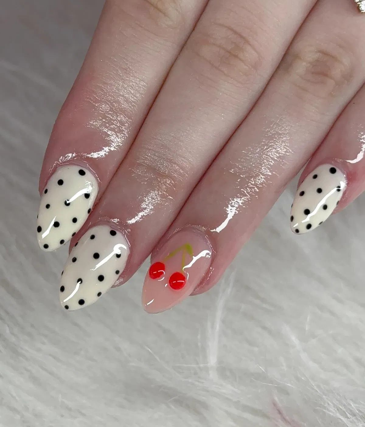 Black polka dots with red-and-green accent detail