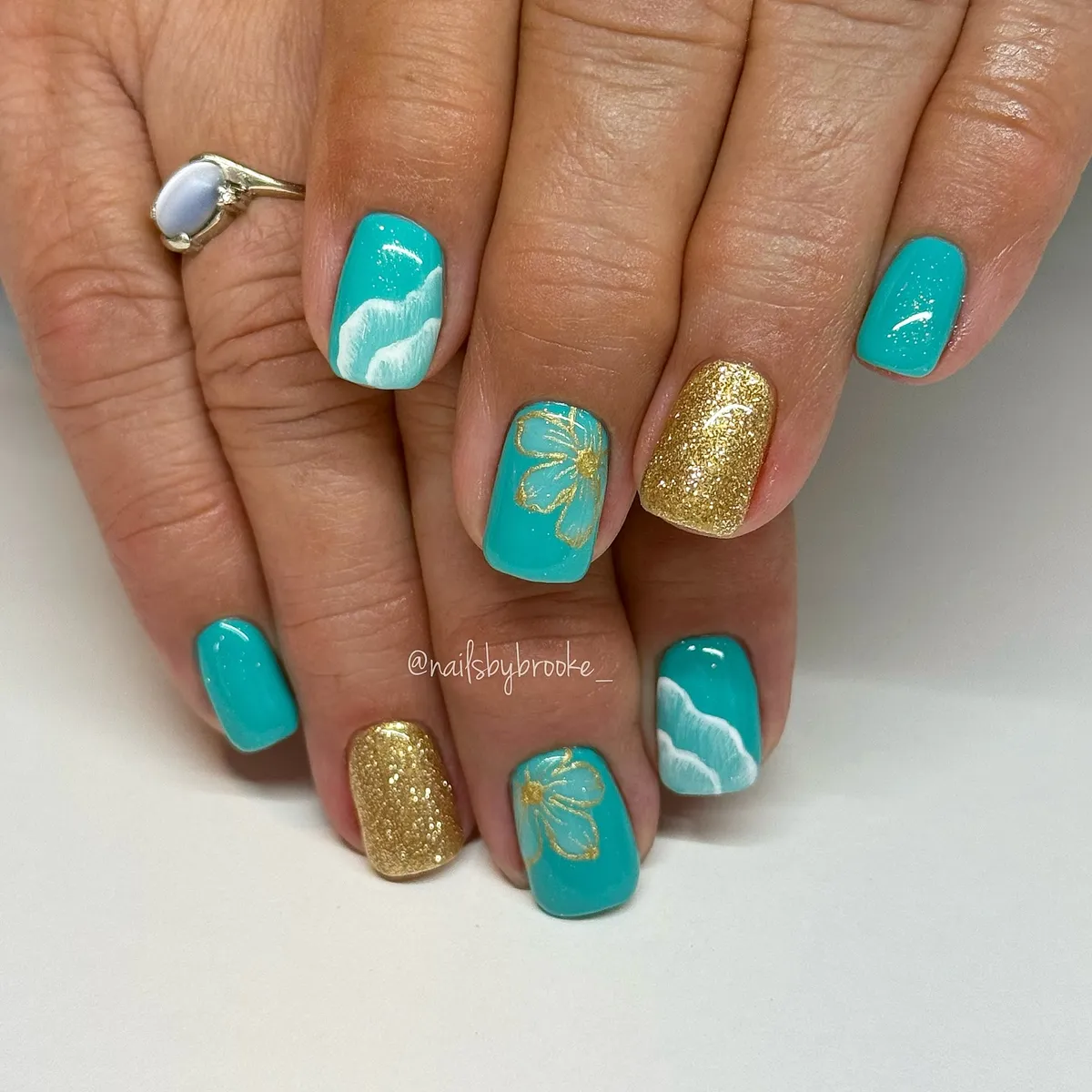 Teal, gold glitter, and white wave accents