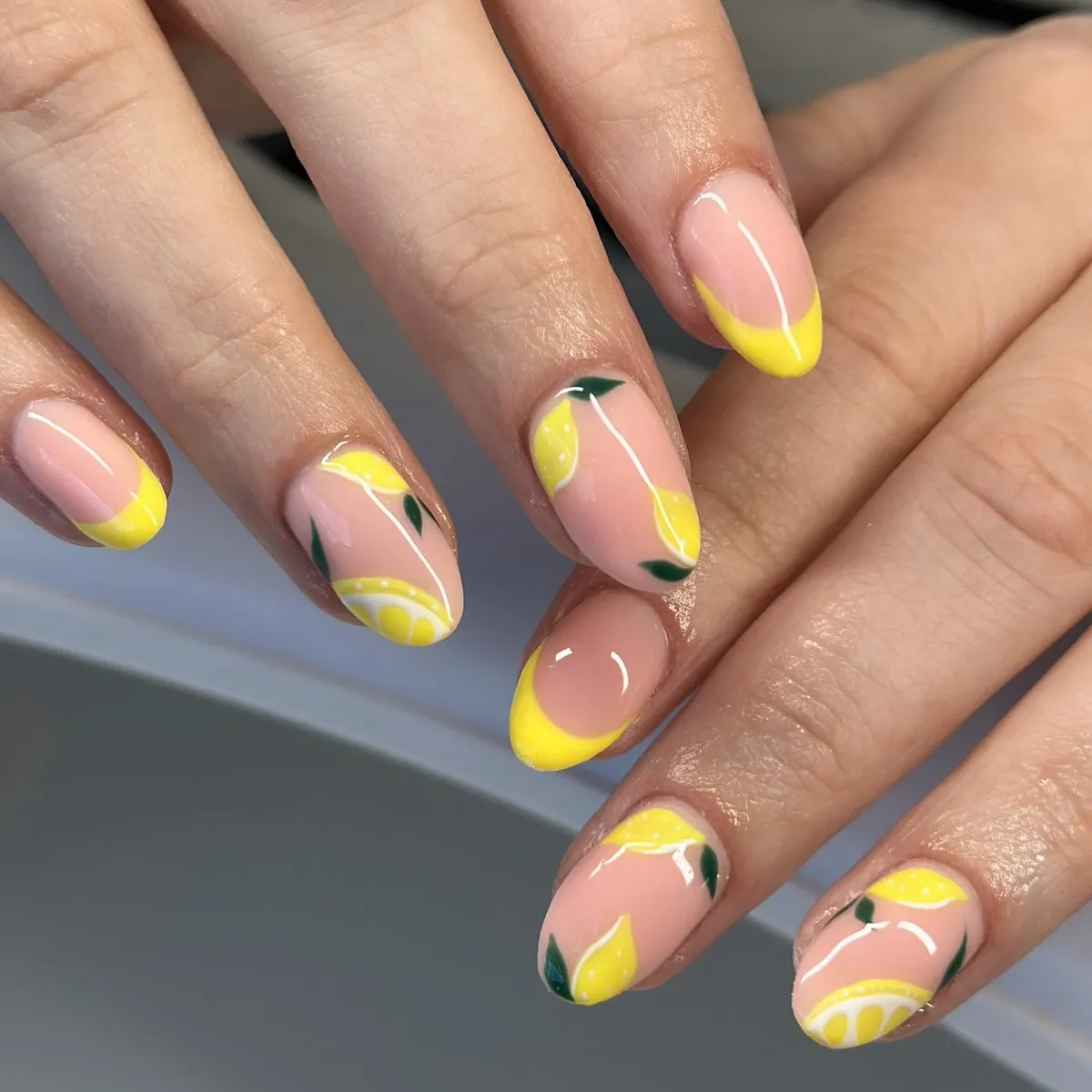 Nude Base with Yellow French Tips and Lemon Motifs