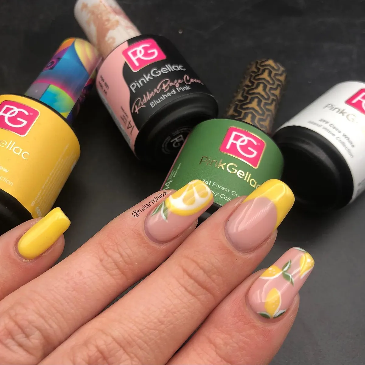 Yellow French tips with lemon slice accent and visible PinkGellac bottles