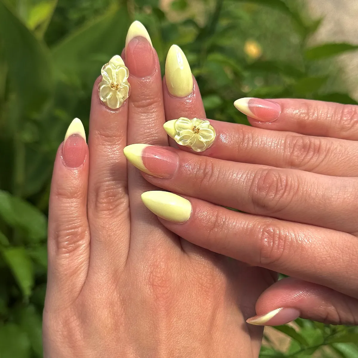 Pale yellow French tips with raised floral accents