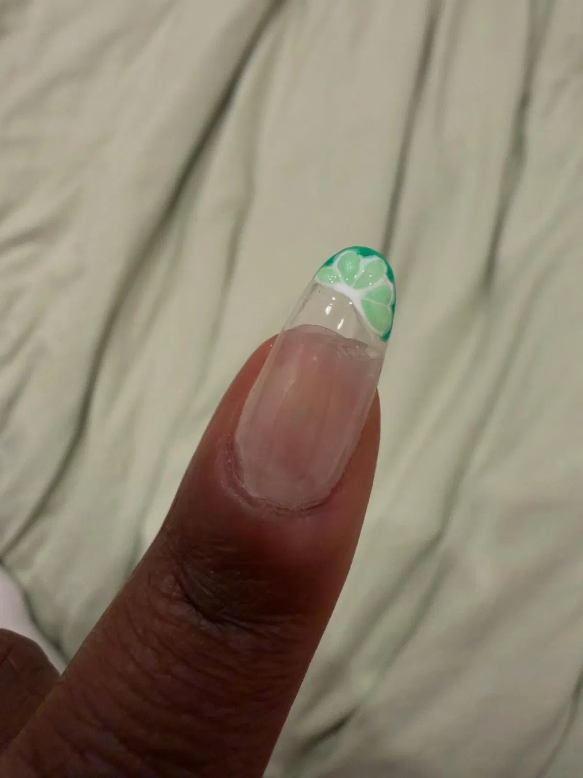 Green citrus-slice French tip on a single nail