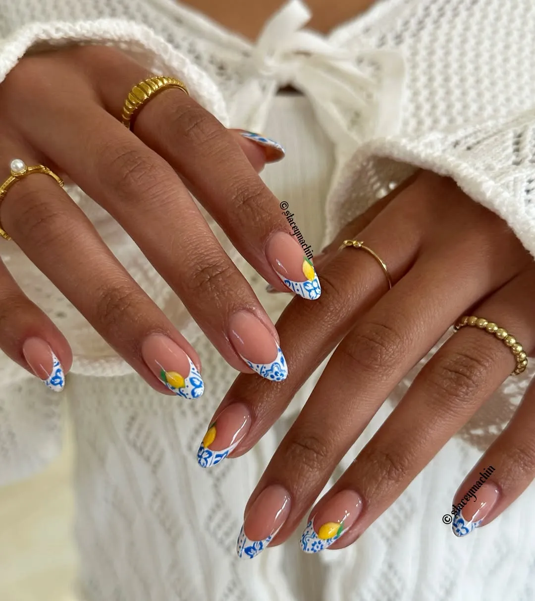 Blue-and-white patterned French tips with yellow fruit accents
