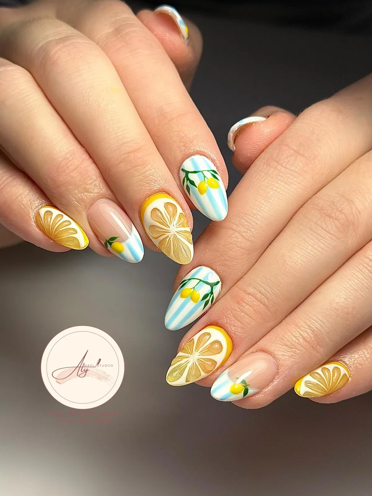 Almond nails with lemon slices and blue striped accents