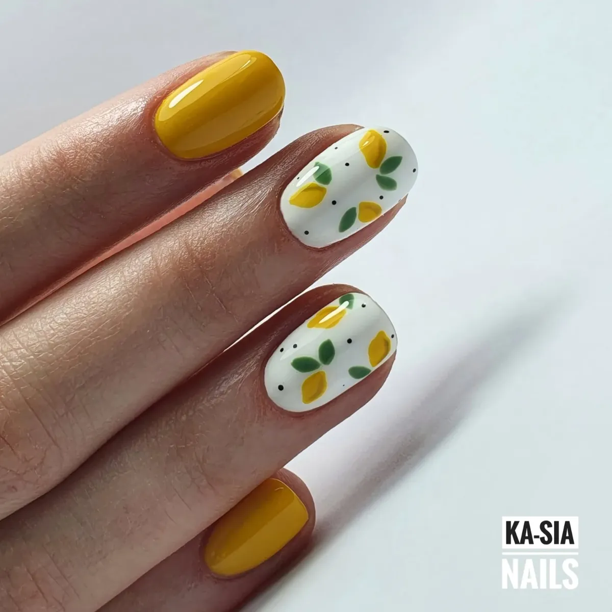 Mustard-yellow solids with white lemon-and-dot accent nails