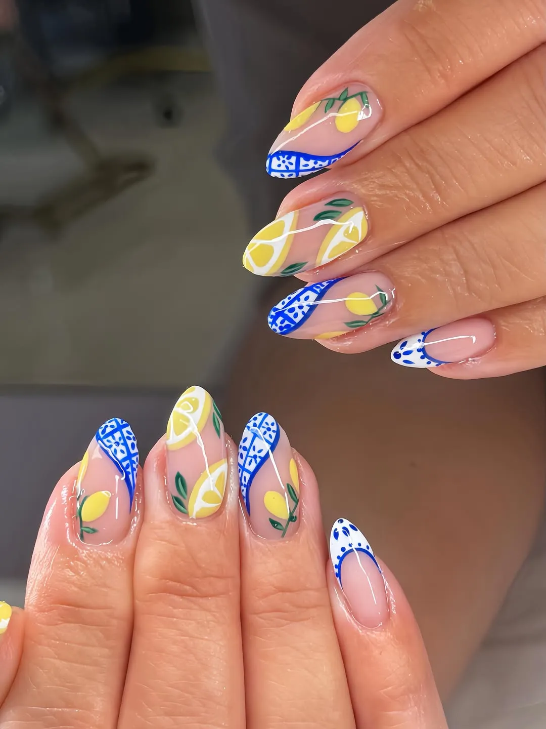Nude base with blue patterned French tips and lemon slices