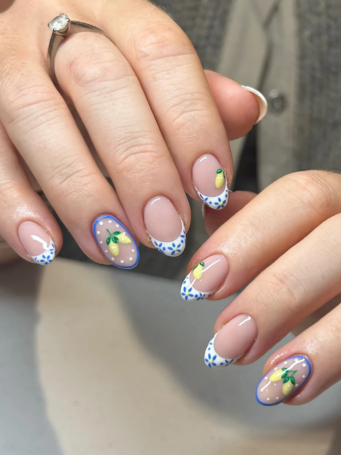 Short French tips with blue detailing and tiny lemons