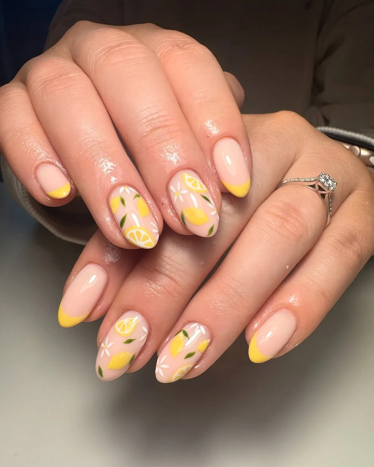 Yellow French tips with lemon-and-flower accents