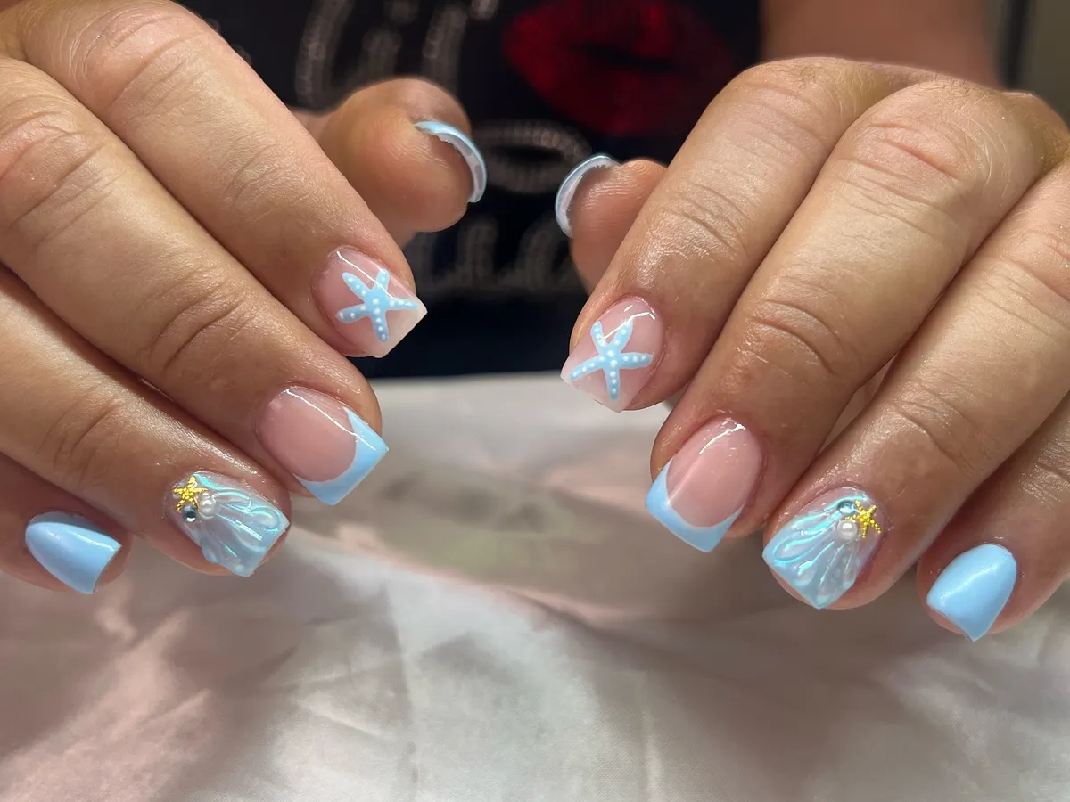 Light blue French tips with starfish and shell accents