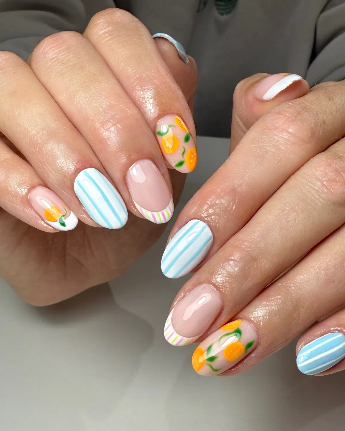 Pastel stripes and orange-fruit accents on a glossy base