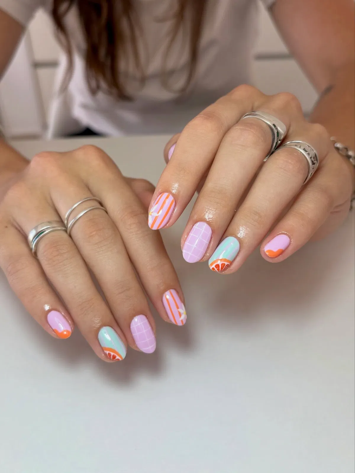 Pastel mix with stripes, grid, and orange slice accent