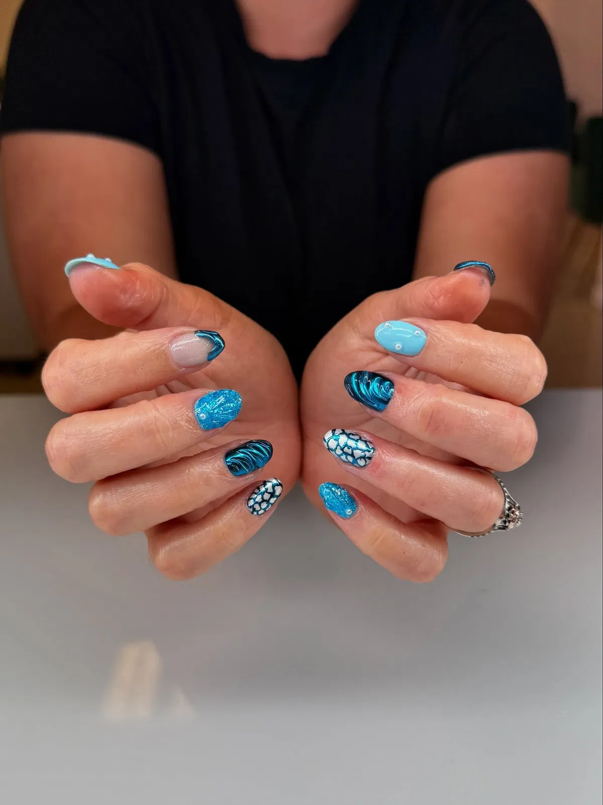 Blue waves, scales, and glitter-speckled accents