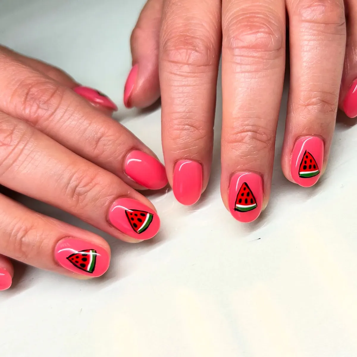 Bright pink nails with triangular slice motifs
