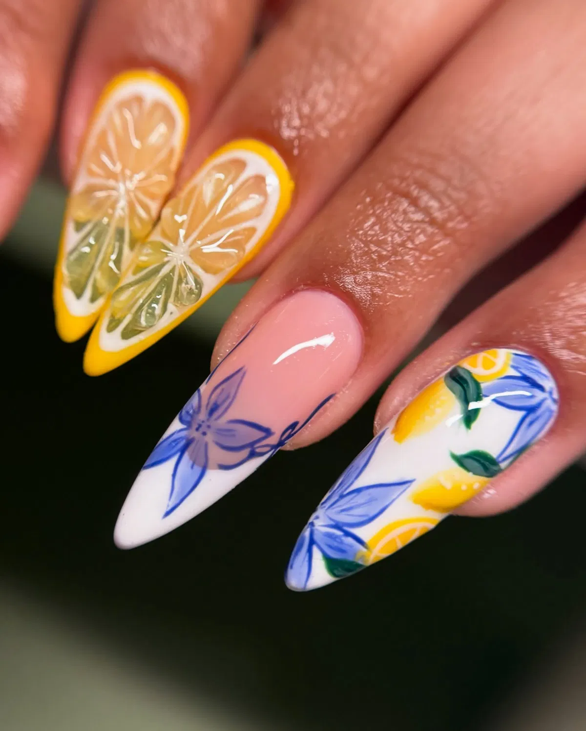 Stiletto nails with oversized citrus slices and blue line art