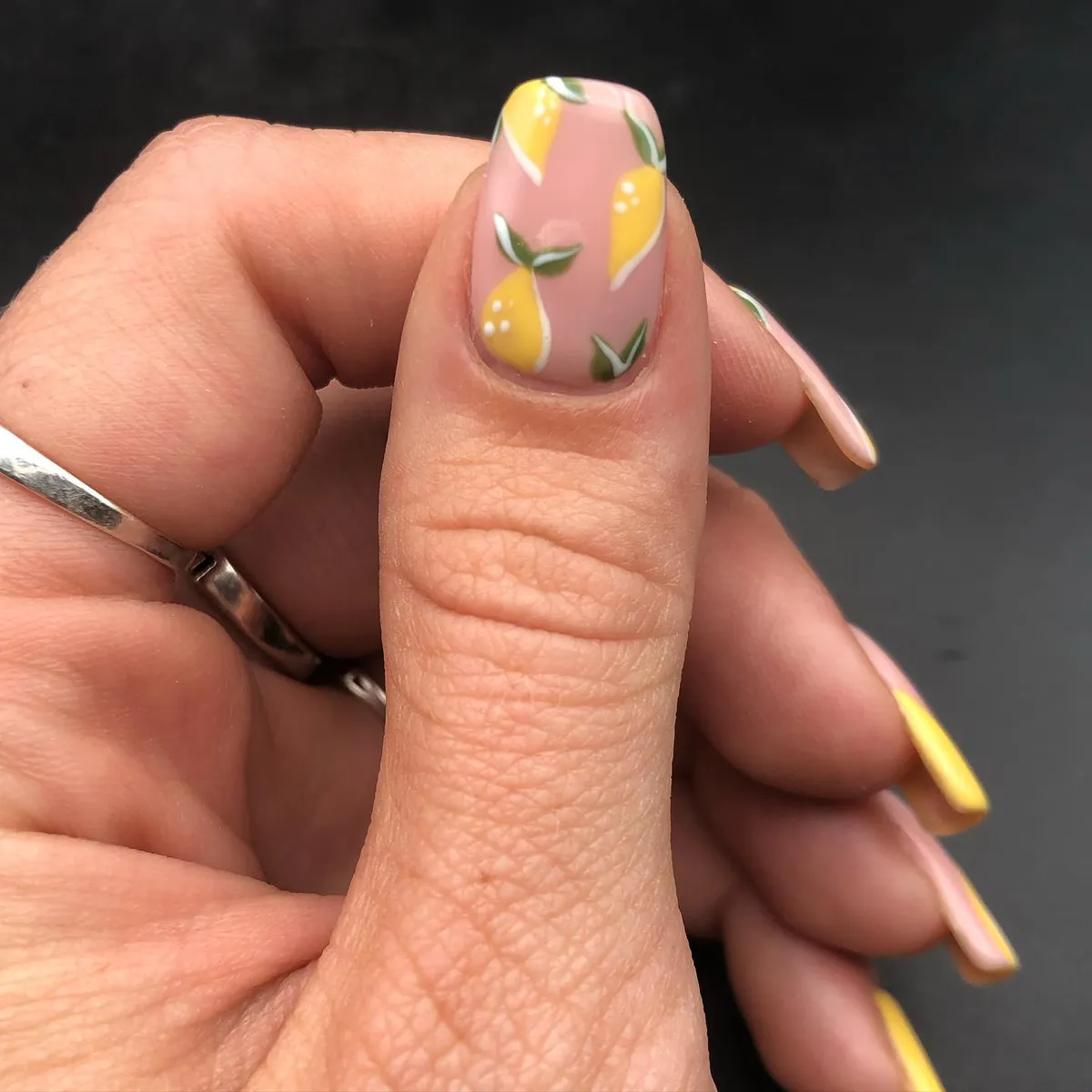 Nude-pink base with repeating yellow fruit pattern
