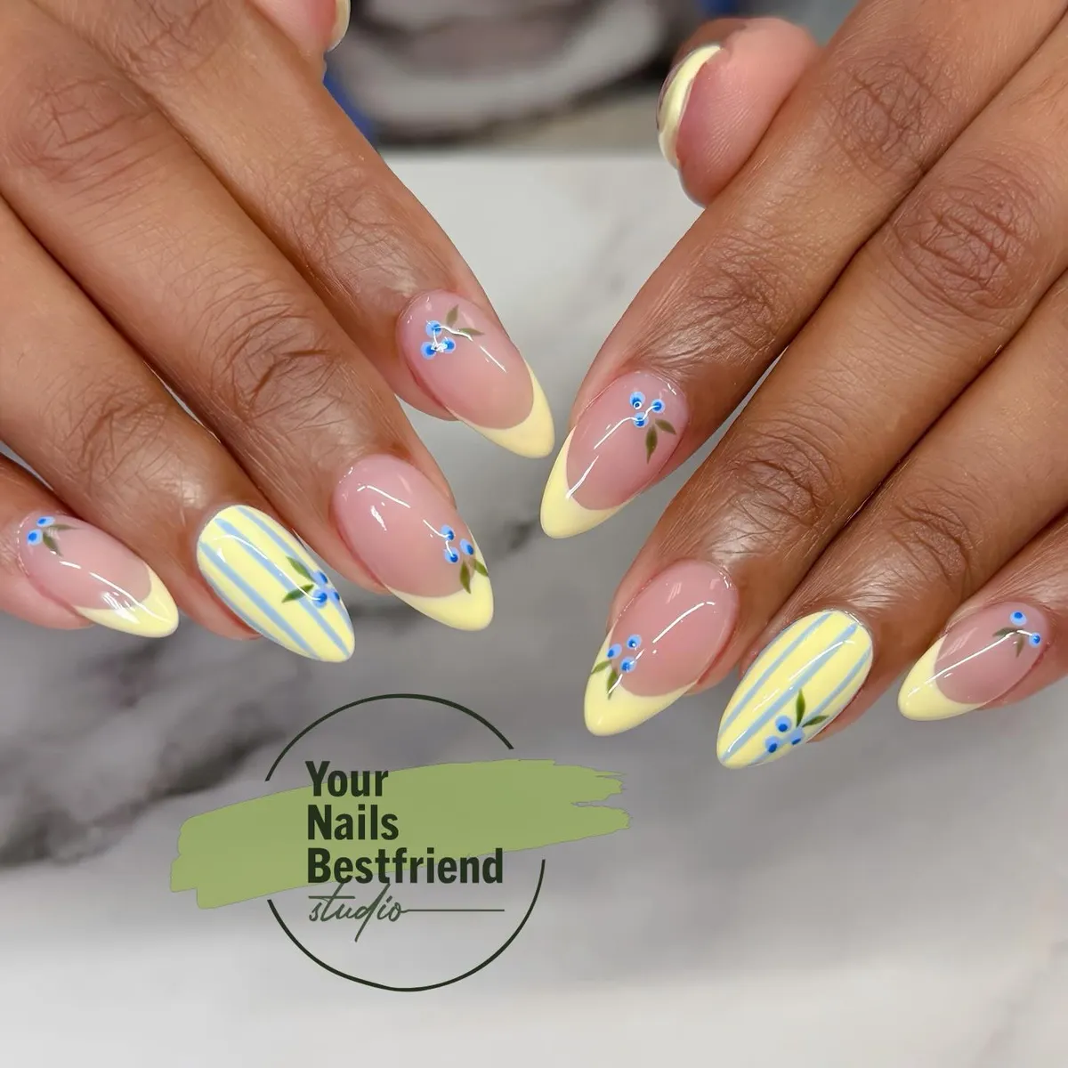 Pale Yellow French Tips with Striped and Small Blue Floral Accents