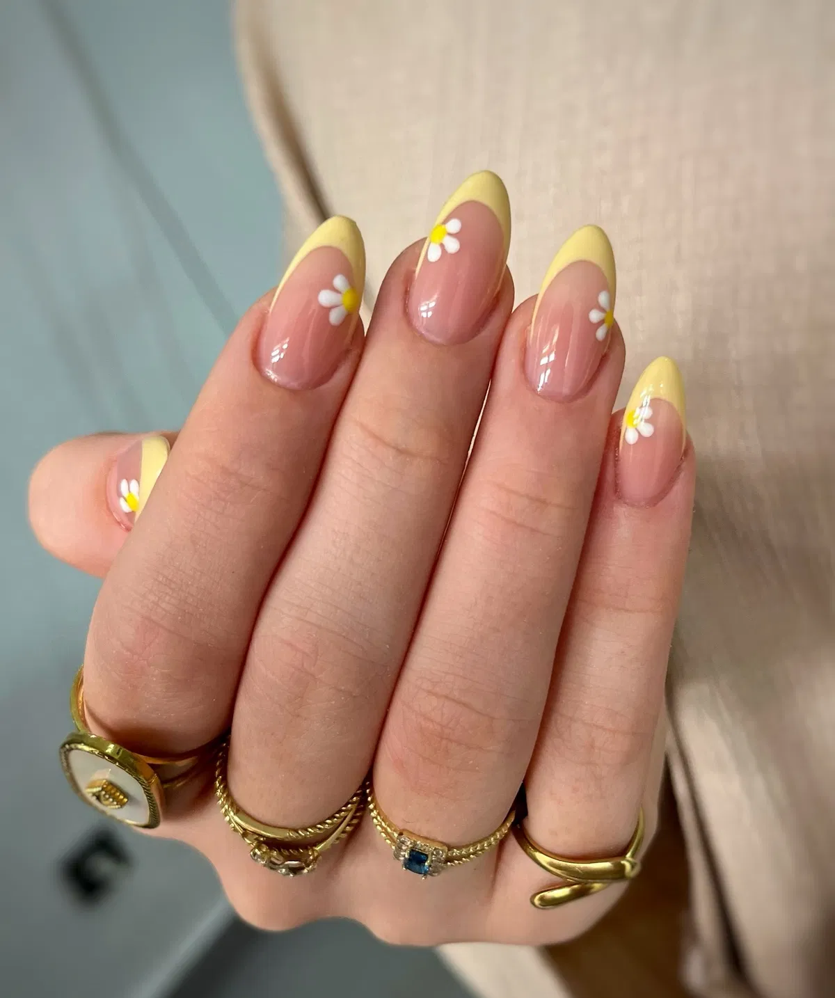 Pastel yellow French tips with small daisies