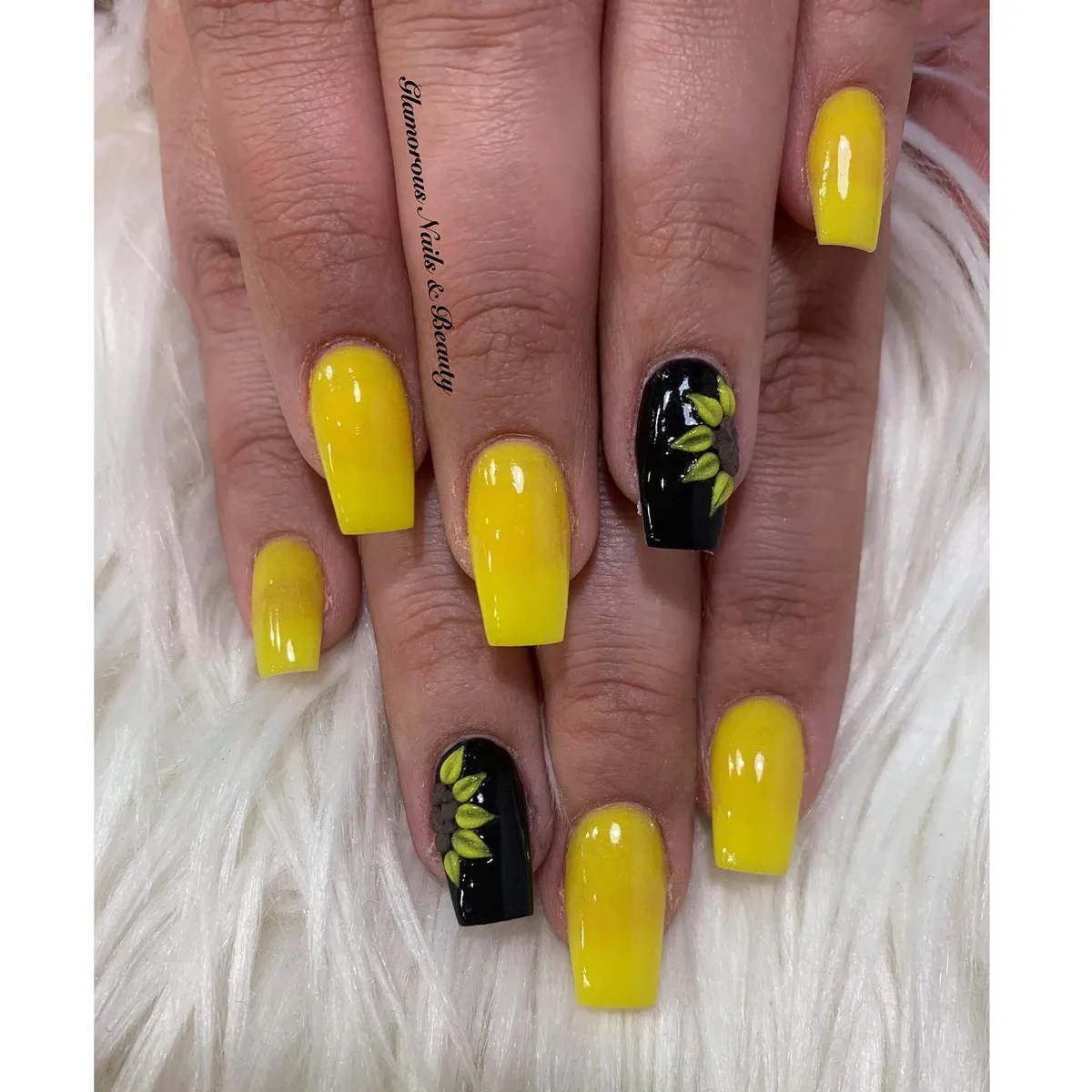 Bright yellow set with black-and-green leaf accent nails