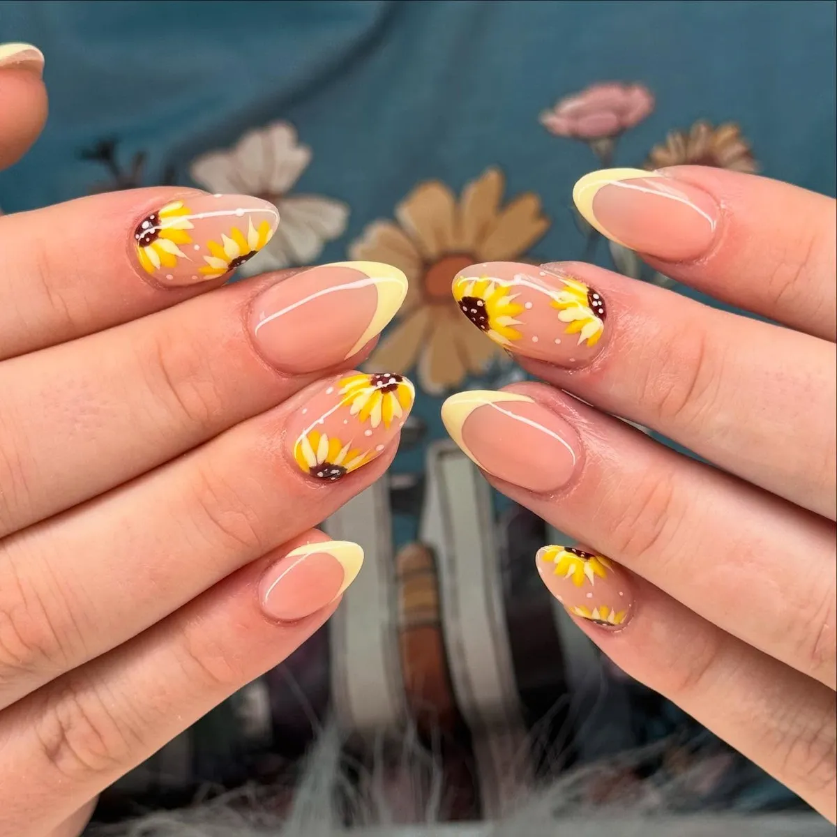 Pale yellow French tips with sunflower-like accent clusters