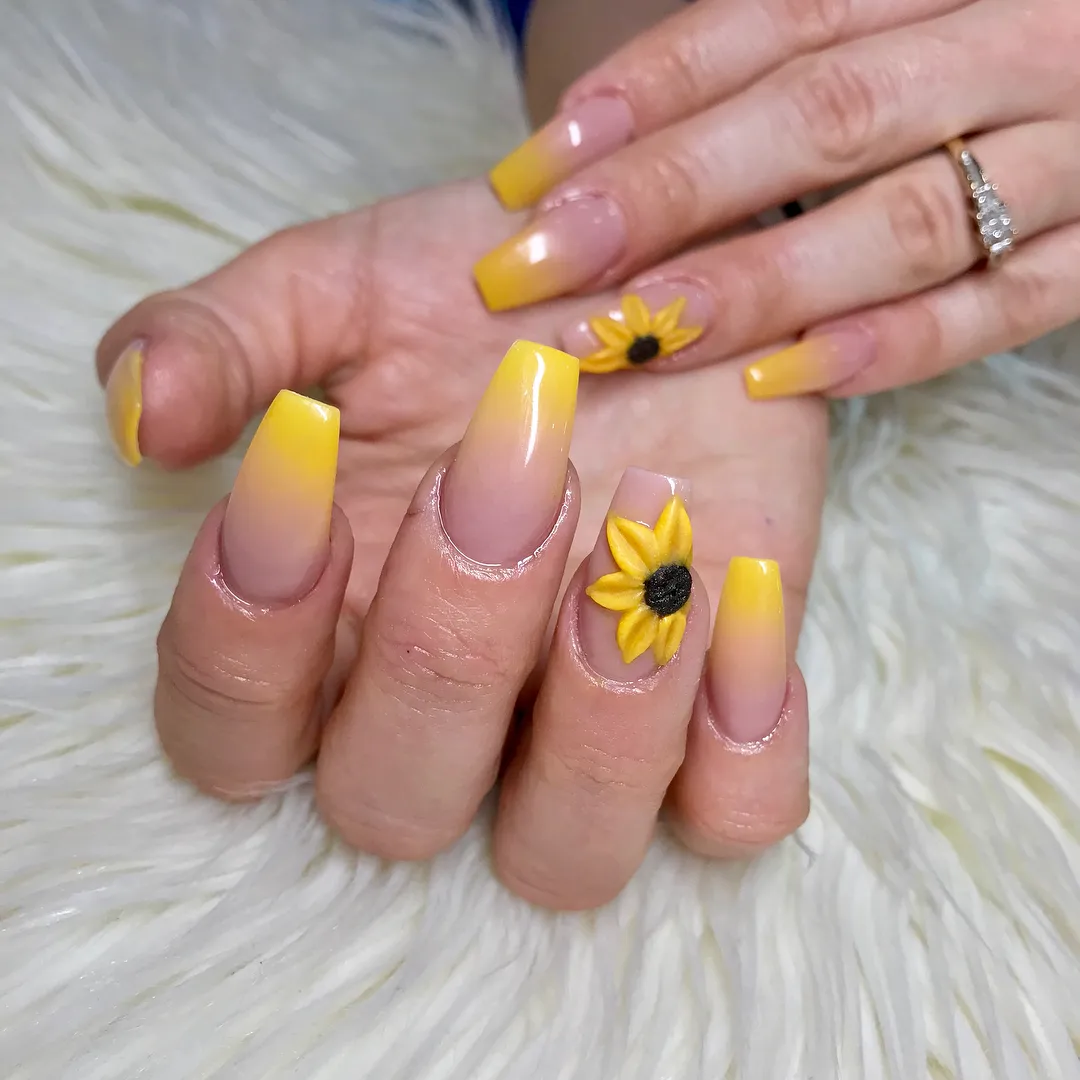 Yellow ombrΓ© tips with raised flower accents