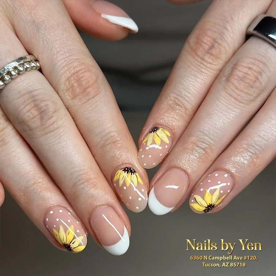 Nude French tips with yellow floral details and white polka dots