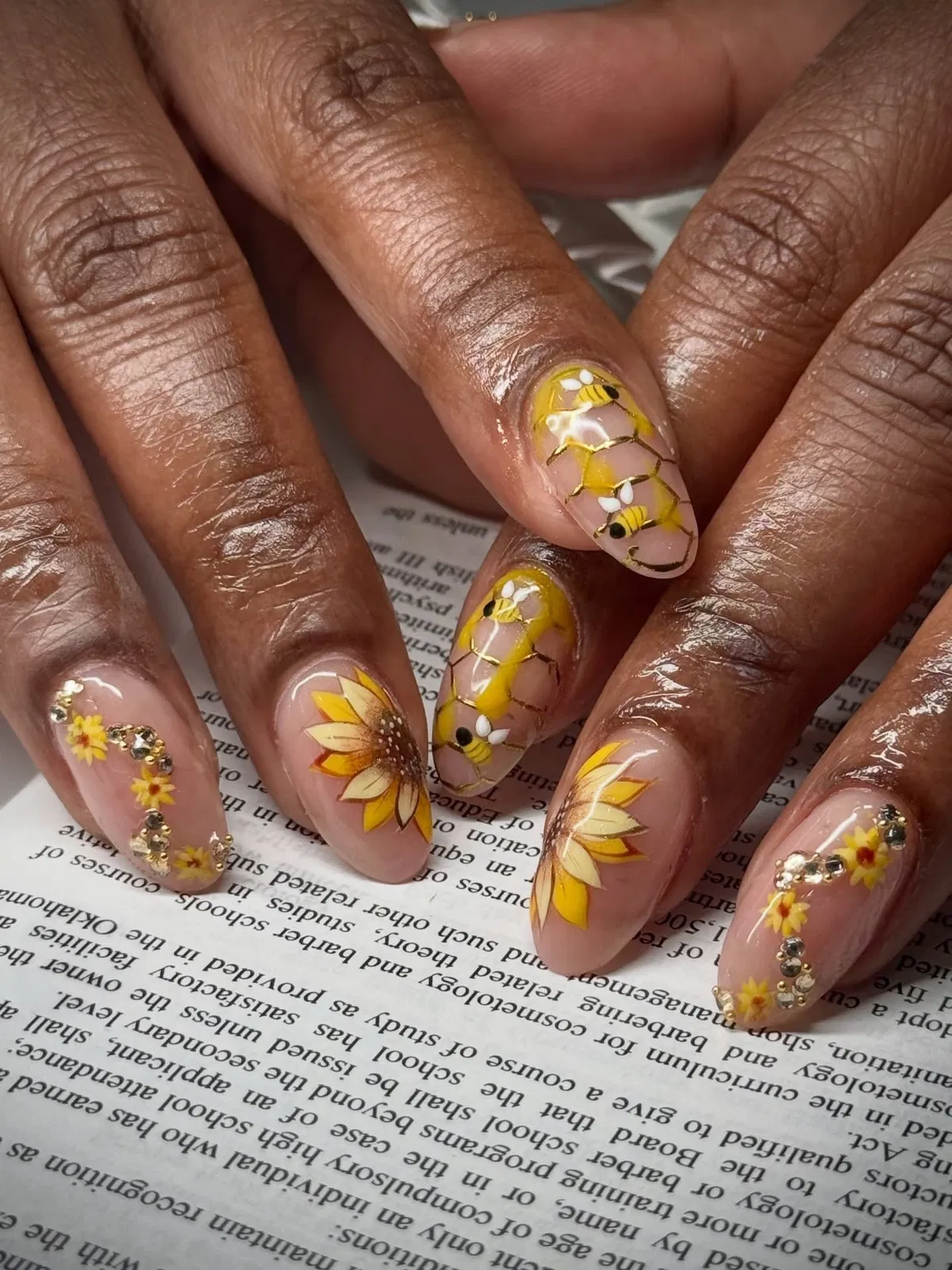 Honeycomb-and-bee accents with large yellow floral nails