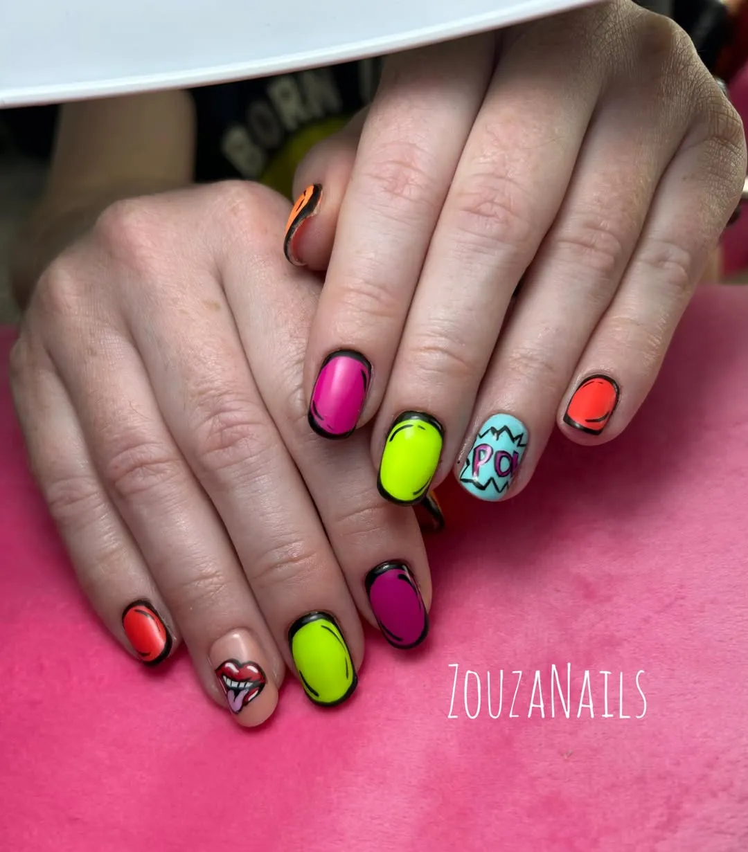 Comic-style neon nails with bold black outlines and “POW” text