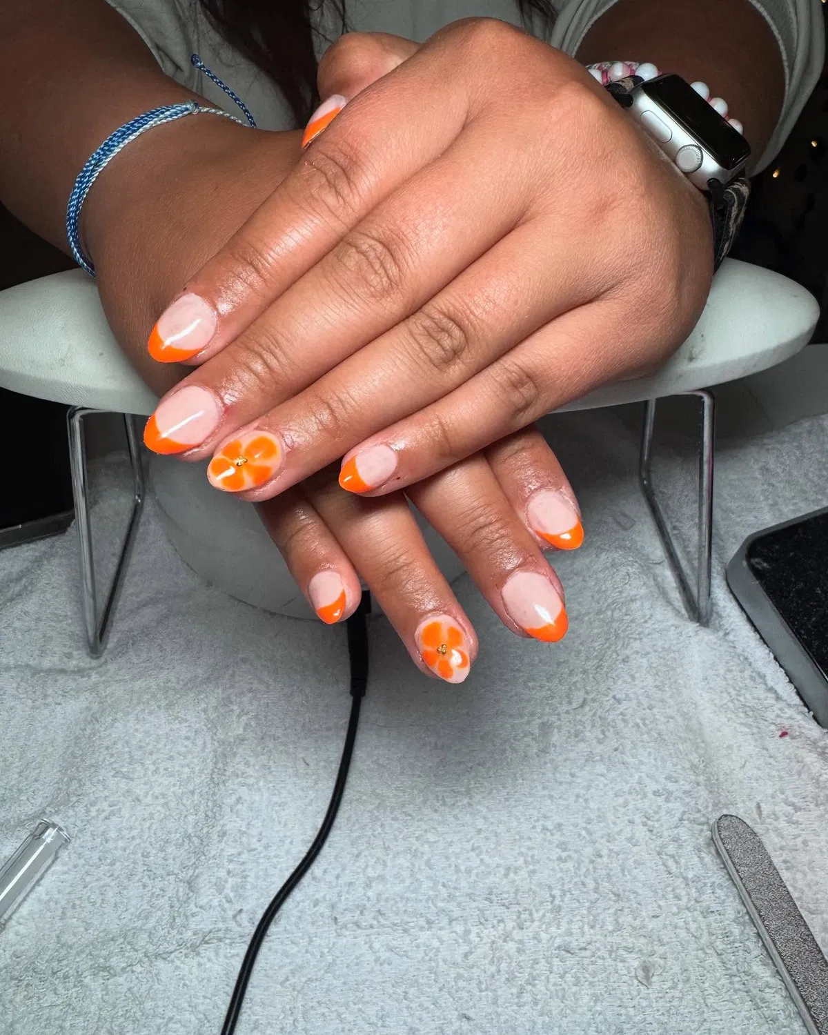 Orange French Tips with Simple Flower Accent