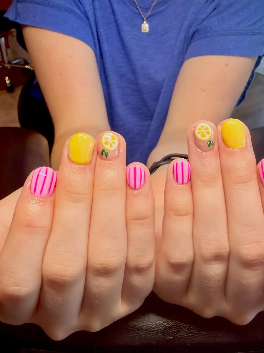 Two-hand view of pink stripes, yellow solids, and lemon accents